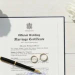 Kompletna lista dokumentów do ślubu kościelnego rozłożona na stole z obrączkami i kwiatami